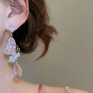 Detail of silver drop earrings with pink butterfly zircon stone and drop pendant