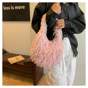 Close-up of pink fluffy feather shoulder bag styled with a minimalist black leather jacket