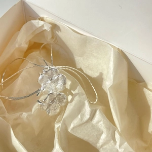 Minimalist S925 sterling silver flower ear clips for women in a white gift box