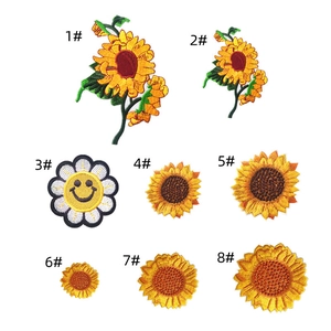 Detail showing 8 distinct sunflower embroidery patches with high-quality needlework texture