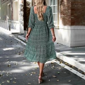 Elegant green floral midi dress with square neck and puff sleeves shown from the back view