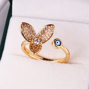 Golden butterfly open ring with sparkling pavé stones and blue evil eye detail