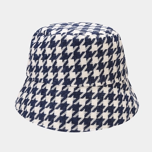Detail of navy and white houndstooth pattern on thick tweed fabric bucket hat