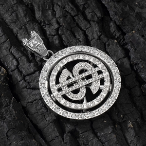Close-up of spinning silver dollar sign pendant with iced-out rhinestones on black charcoal