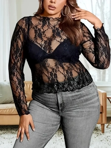 Detail of sheer black lace fabric on long sleeve shirt with floral pattern for women