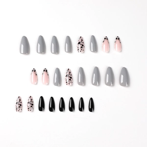 Glossy almond press-on nails with grey-black dots and gold line designs set