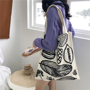 Minimalist cream canvas tote bag with hand-drawn leaf and fruit prints in a large size