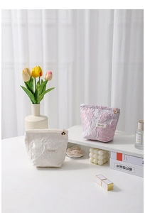 Detail of floral texture cosmetic bags with flower zipper and H&R BAG label