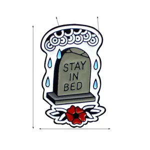 Detail view of Stay In Bed tombstone enamel brooch with size specs and cloud motifs