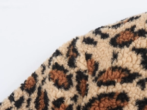 Close-up of leopard print polar fleece fabric with soft texture and detailed pattern