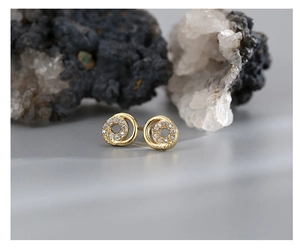 Detail of gold-plated hoop earrings featuring a sparkling white zircon pavé setting