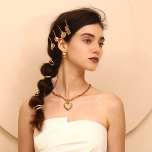Close-up of 18K gold-plated lip-shaped hair tie and matching jewelry set on a model