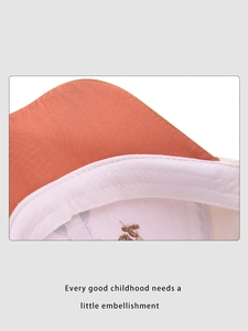 Close-up of kids' baseball cap interior with orange cotton fabric and sweatband
