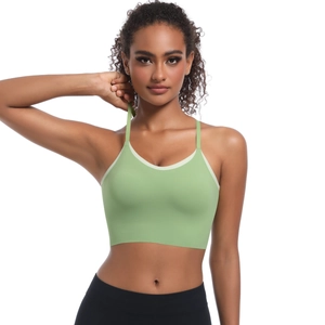 Detail of light green sports bra with thin straps and contrast piping on the neckline