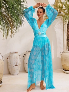Detail of blue sheer mesh V-neck beach cover-up with white seashell prints and waist buckle