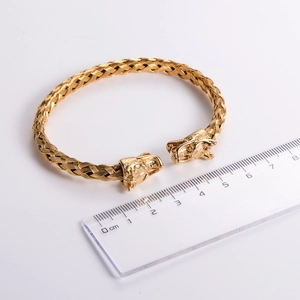 Close-up of 18k gold plated stainless steel dragon head bracelet with measuring ruler