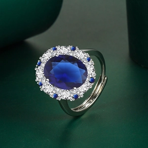Detailed macro shot of vintage oval blue gemstone ring with sparkling diamond halo