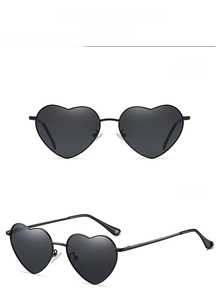 Detail of heart-shaped sunglasses C1 with black metal frames and spring hinges