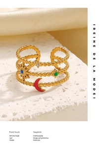 Detailed shot of gold-plated beaded celestial ring with colorful enamel moon and stars