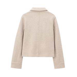Back view of beige short wool jacket showing minimalist cut and vertical seam detail