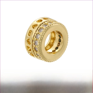 Detail view of gold brass honeycomb spacer bead with hollow hearts and zircon accents