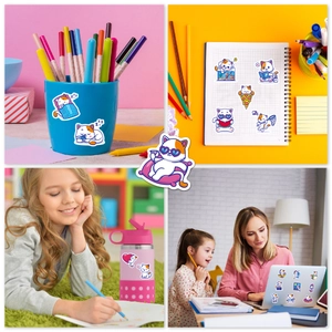 Detailed view of waterproof cartoon cat stickers applied to a pencil cup and laptop