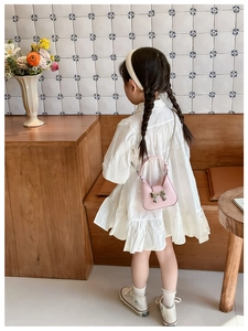 Pink PU crossbody bag for kids featuring a silver bow decoration and metal chain strap