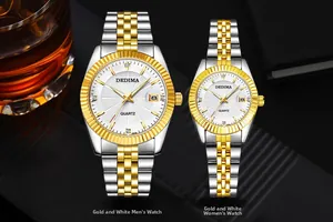 Close-up of luxury gold and silver quartz watches with white dials and date window