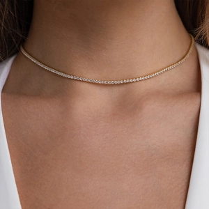 Close-up of gold-plated tennis necklace featuring pavé-set square zircon stones