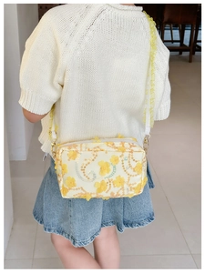 Detailed back view of a floral kids crossbody bag with yellow sequins and ruffle strap