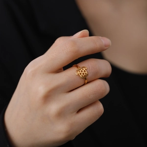 18K gold plated stainless steel sea turtle ring featuring cutout design on model finger