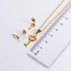 Macro shot showing crown key pendant size of 3.5cm and stud earrings in gold titanium steel