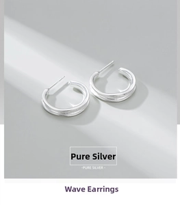Detailed macro shot of wavy texture on S925 sterling silver hoop earrings with bright finish