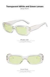 Detail view of rectangular sunglasses featuring transparent white frames and green lenses