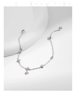 Detailed view of sterling silver lucky clover bracelet with shimmering white zircons