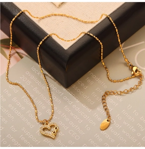 Macro shot of gold-plated infinity heart pendant necklace with shimmering crystals