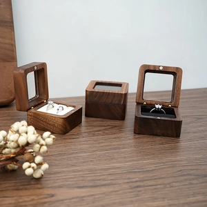 Detail of walnut wood ring box with clear window and velvet lining for jewelry storage