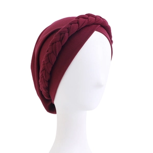 Detail of wine red turban cap featuring elastic fabric and braided twist design
