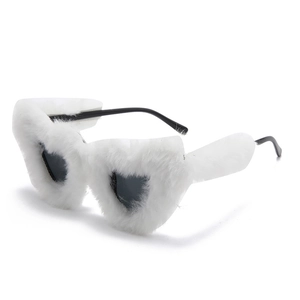 Detail view of heart-shaped sunglasses with white plush fur edges and black lenses