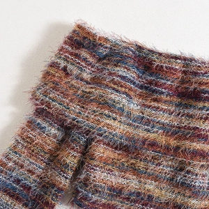Detail shot of multicolor long-hair faux fur knit fabric with soft textured mixed fibers