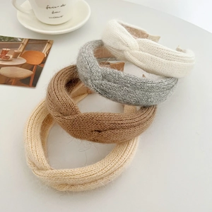 Knitted crossover headbands in neutral colors with a thick cable knit texture design