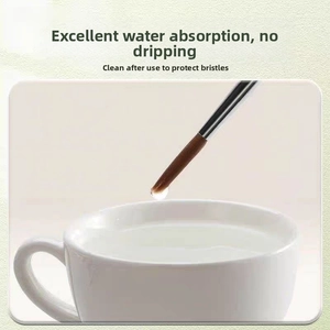 Detail showing high water absorption with a drop hanging on the fine pointed brush tip