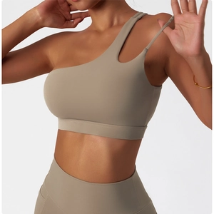 Detail view of the irregular one-shoulder strap and cut-out design on yoga sports bra
