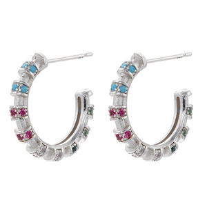 Detail of silver C-shaped earrings with colorful zircon inlay and 18K gold plating