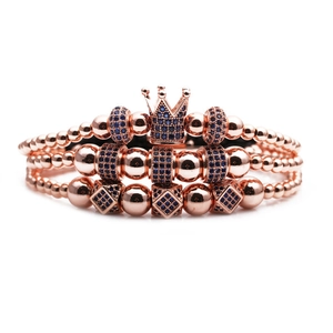 Three-piece rose gold crown bracelet set with blue zircon beads on white background