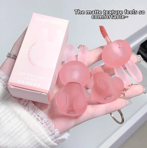 Close-up of cute pink rabbit-shaped matte lip mud with portable keychain lid and applicator