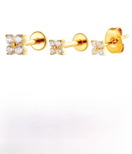 Detailed macro view showing titanium alloy flower labret studs in silver and gold finishes
