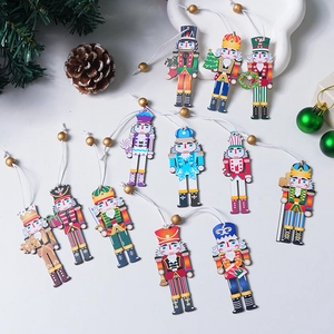 Detailed view of 9-piece wooden nutcracker ornament set with pine cones and holiday decor