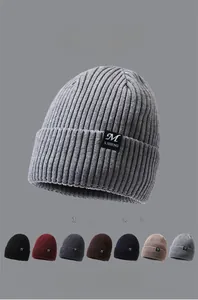 Detail view of ribbed knit beanies showing multiple color options and soft fleece lining