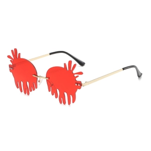 Trendy red fluid drip frameless sunglasses with gold metal arms and punk style lenses